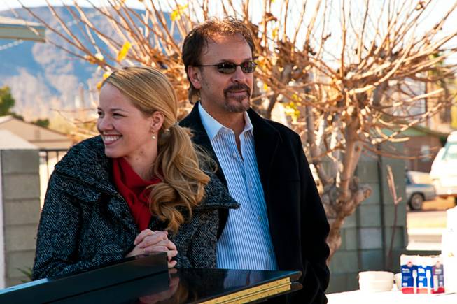 Kristen Hertzenberg, of Phantom, and Philip Fortenberry, Associate Conductor for Jersey Boys, prepare to perform their version of a Christmas carol for the Ramos family, Saturday Dec. 24, 2011. In12Days, a charity organization, surprised the Ramos family with an unforgettable rendition of the 12th day of Christmas.